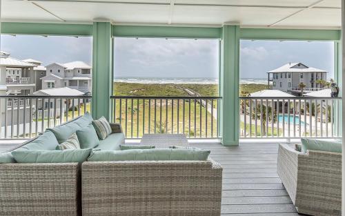 a living room with a couch and a view of the ocean at All Decked Out in Padre Island