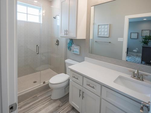 a bathroom with a toilet and a shower and a sink at All Decked Out in Padre Island