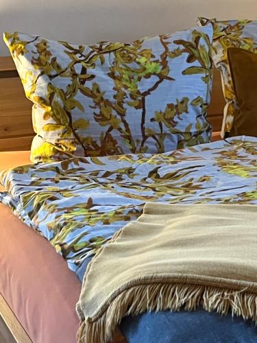 a bed with a pillow on top of it at LICHTECK - Helle Ferien in Breitenberg