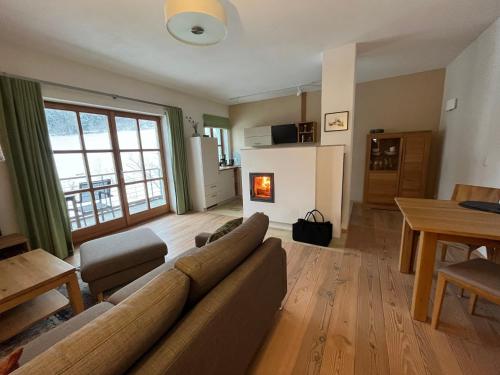 a living room with a couch and a table at LICHTECK - Helle Ferien in Breitenberg