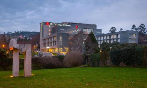 a building with a sign on top of a field at NH Collection Santiago de Compostela in Santiago de Compostela