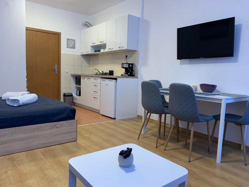 a small room with a bed and a table with chairs at Studios and Apartments - Semiramida Gardens in Borovets