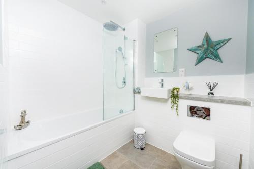 a white bathroom with a starfish on the wall at Brand New Luxury 1-Bed Apartment in Liverpool in Liverpool