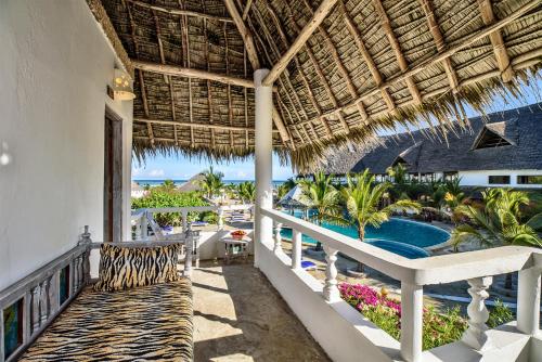 a resort balcony with a view of the ocean at Jacaranda Beach Resort in Watamu