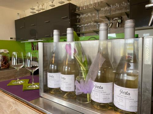 a bunch of bottles of wine sitting on a counter at Traubengarten Winkler in Niederhollabrunn