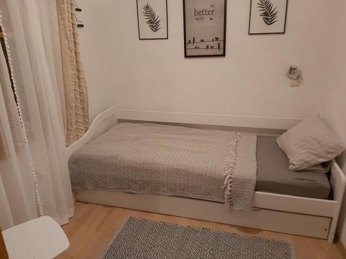a small bedroom with a bed in a room at InGreen house in Bohinjska Bela