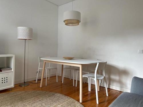 a white table and chairs in a living room at LX Factory Apartment 1 in Lisbon