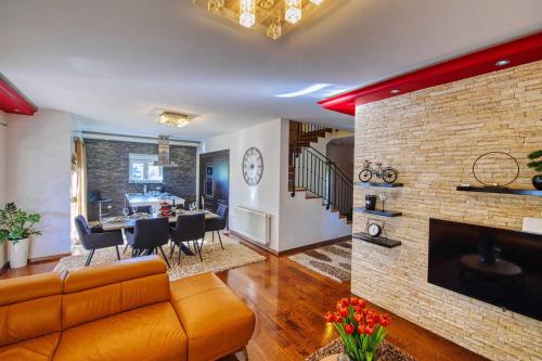 a living room with a couch and a brick wall at Villa Enna with heated pool, Zadar in Crno