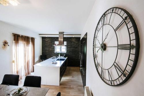 a kitchen with a large clock on the wall at Villa Enna with heated pool, Zadar in Crno
