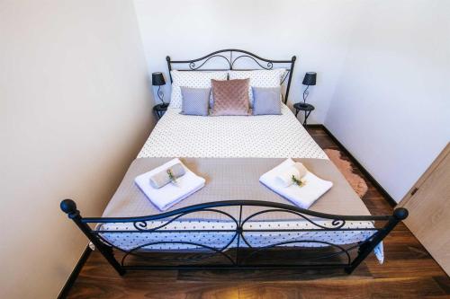 a bedroom with a bed with two pillows on it at Villa Enna with heated pool, Zadar in Crno
