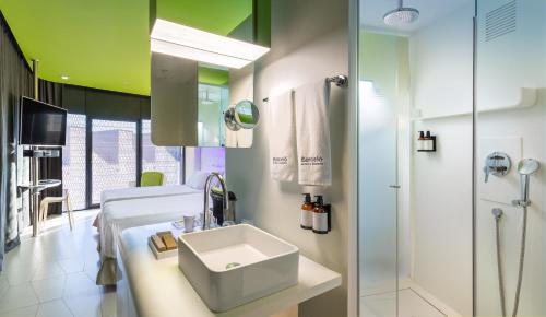 a bathroom with a sink and a shower at Barceló Raval in Barcelona