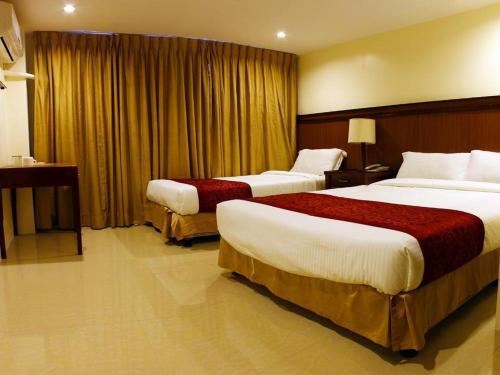 a hotel room with two beds in a room at Chinatown Lai Lai Hotel Inc in Manila