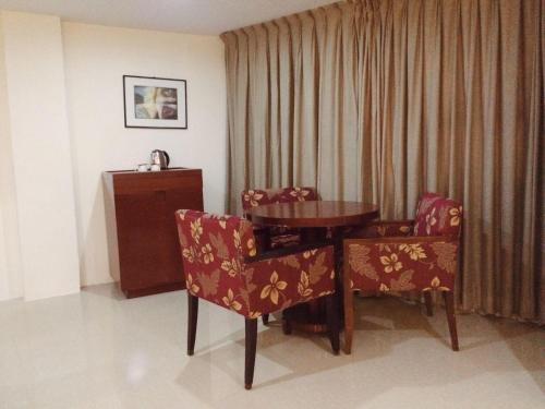 a dining room table and chairs in a room at Chinatown Lai Lai Hotel Inc in Manila