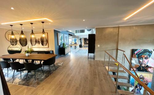 a dining room and living room with a table and chairs at Beyond Paradise in Knysna