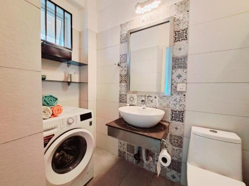 a bathroom with a washing machine and a sink at Seaview Modern Studio in Sihanoukville