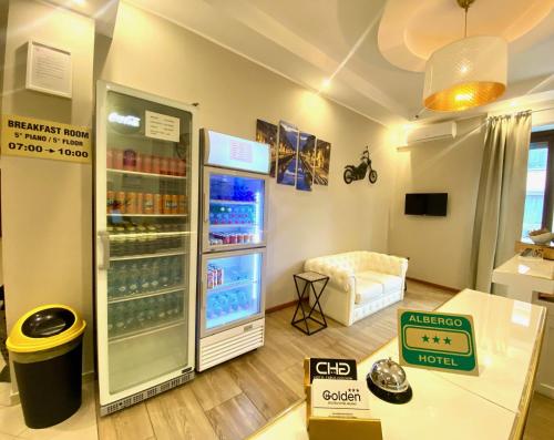 a room with a refrigerator filled with drinks at Golden Milano Hotel in Milan