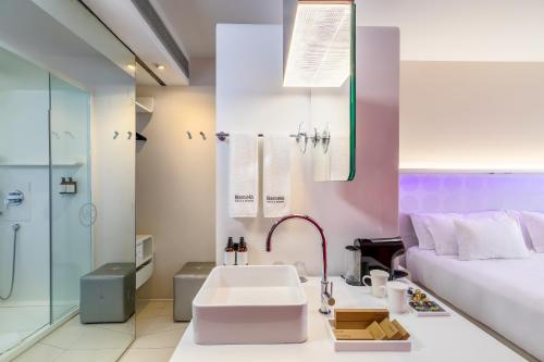 a bathroom with a sink and a bed at Barceló Raval in Barcelona