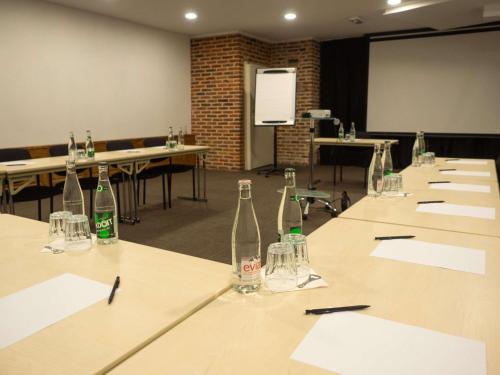 a conference room with empty bottles on a table at ibis Douai Centre in Douai