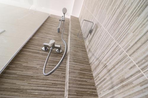 a shower in a bathroom with a wooden floor at Holiday home Galatea a Otranto in Otranto