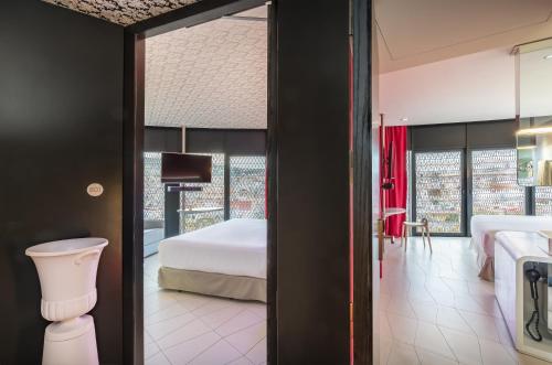 a hotel room with a bed and a window at Barceló Raval in Barcelona