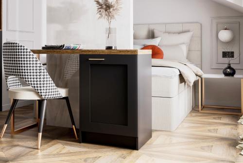 a bedroom with a bed with a desk and a chair at boutique Villa Dorma in Dubrovnik