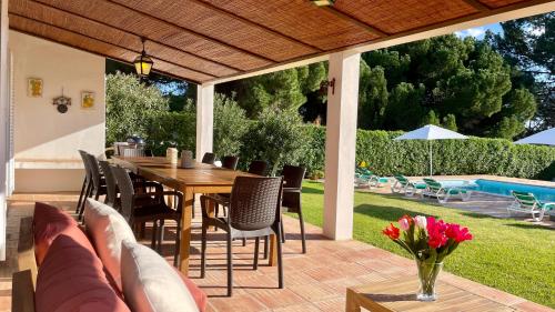 a patio with a wooden table and chairs at Sol by Check-in Portugal in Vilamoura