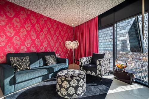 a living room with a couch and a chair at Barceló Raval in Barcelona
