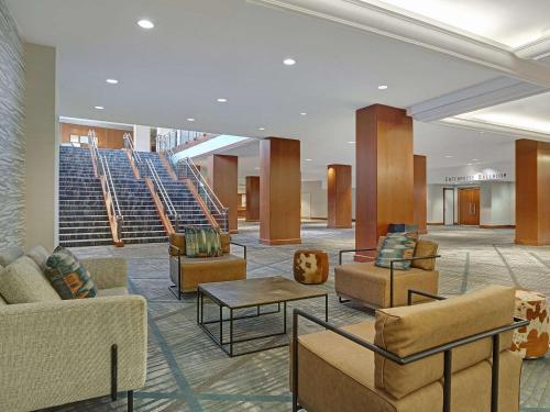 a lobby with couches and tables and stairs at Hyatt Regency DFW International Airport in Dallas