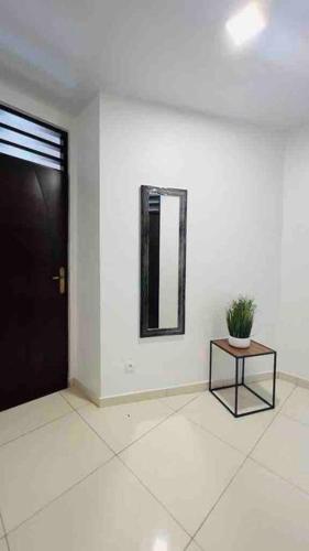 a room with a black door and a table with a plant at VILLA FRUIT A PAIN T3 in Cayenne