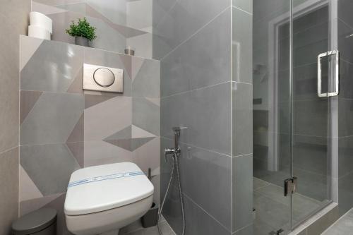 a bathroom with a toilet and a shower at Jam Apartments Miskevycha in Lviv