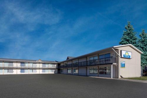 an office building with a large parking lot at Days Inn by Wyndham Birch Run in Birch Run