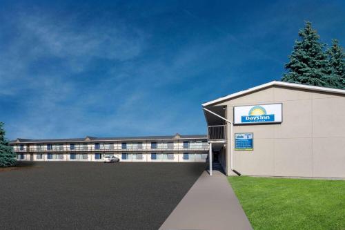 a large building with a parking lot in front of it at Days Inn by Wyndham Birch Run in Birch Run