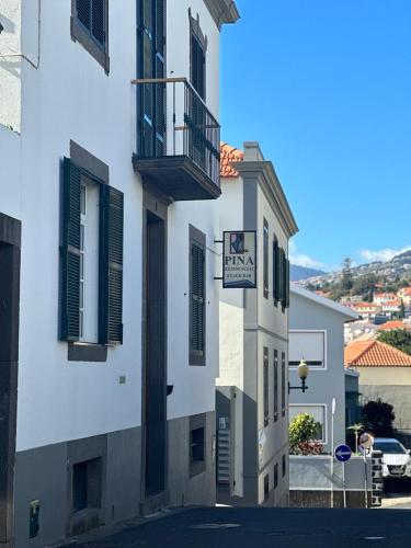 a white building with a sign on the side of it at Valhalla Panorama in Funchal
