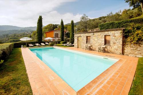ein großer Pool vor einem Haus in der Unterkunft Casetta di Butia, Glicine Apartment in Borgo a Mozzano