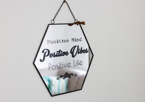 a hanging sign that says positive mindset positive vibes positive life at Apartman Teo in Lukavica