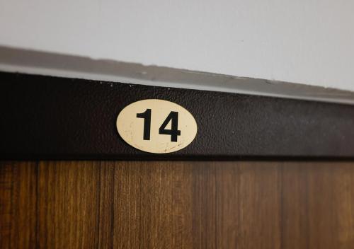 a sign on a door with the number on it at Apartman Teo in Lukavica