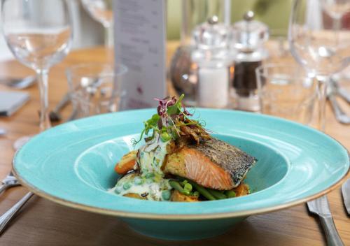 a blue plate of food on a table at Heacham Manor Hotel in Hunstanton