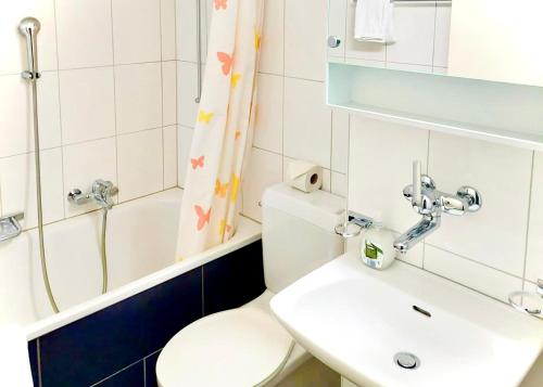 a bathroom with a toilet and a sink and a shower at El Hamra - cozy - by PA in Luzern