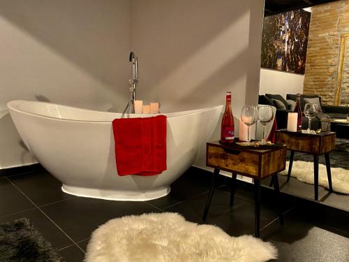 a bathroom with a bath tub with a red towel at Kiraly street , Stylish Apartment in Budapest