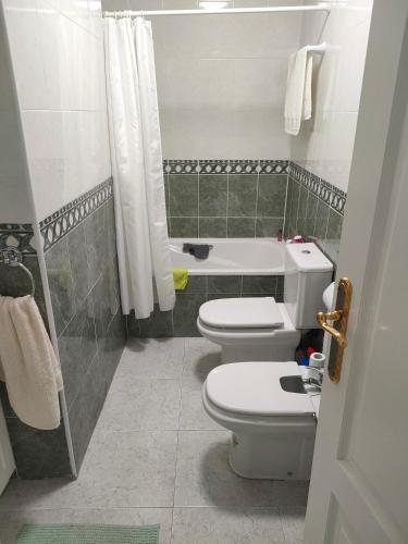 a bathroom with two toilets and a shower at Casas Holiday - Golf Campoamor in Orihuela Costa