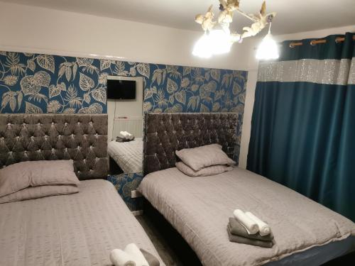 a bedroom with two beds with towels on them at 116 maison dieu Road room B in Dover in Dover
