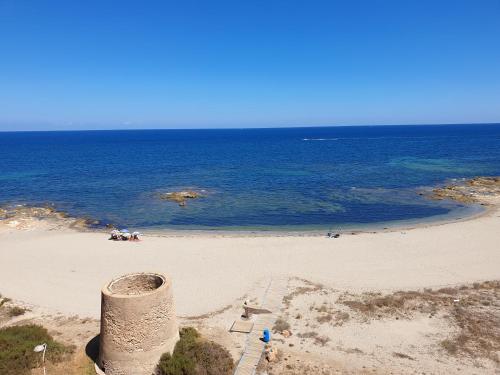 a beach with a pipe in the middle of the ocean at Apartamento Rokita Blanca in La Manga del Mar Menor