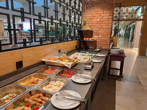 a buffet line with many different types of food at Hotel ETNA in Gračanica