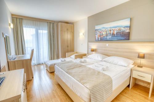 a hotel room with two beds and a large window at Hotel Villa MiraMar in Omiš