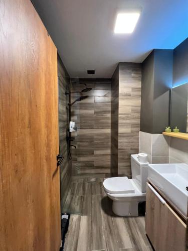 a bathroom with a toilet and a sink at Marshall Gudauri Apartment SkiCasa in Gudauri