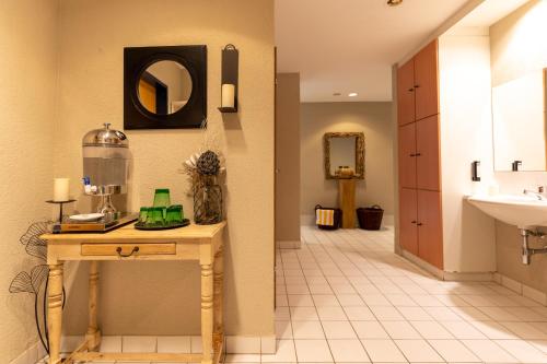 a bathroom with a sink and a mirror at Hotel Tia Monte Nauders in Nauders