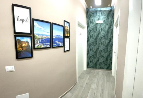 a hallway with framed pictures on a wall at Valentine’s house in Naples