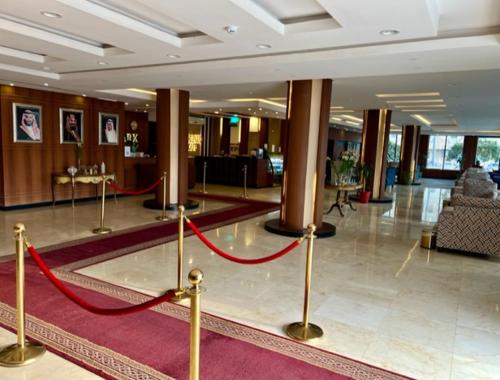 a lobby with a red ribbon in a building at Rose Park Riyadh in Riyadh