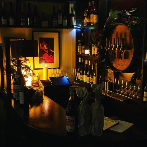 a bar with bottles of alcohol and a mirror at The Old School House in Clifden