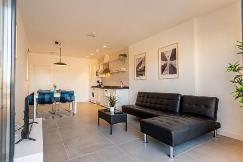 a living room with a couch and a table at Edificio Santiago by Plaza Mayor Apartamentos in Valladolid